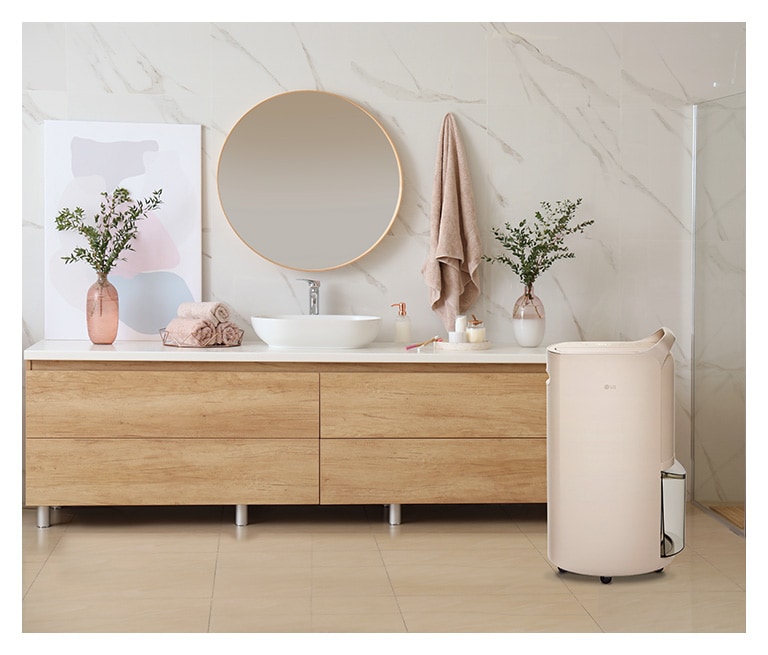 It shows calming beige color LG Puricare™ Dehumidifier is placed in a bathroom.