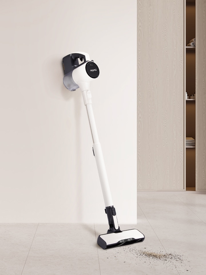 Stick vacuum leaning against the wall.