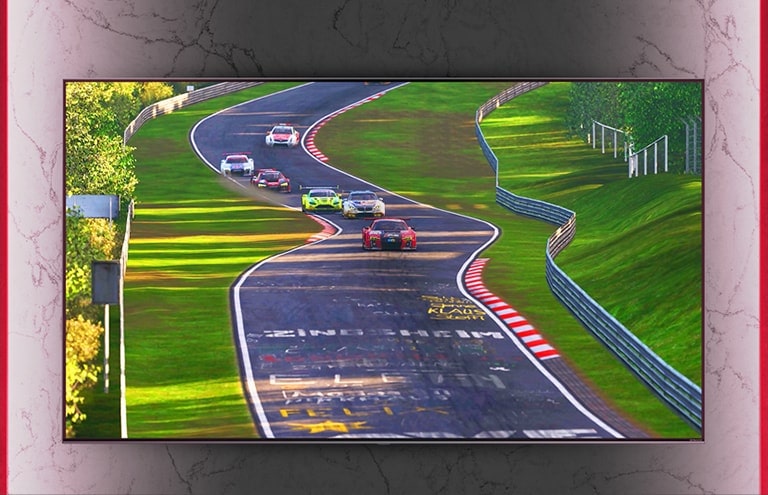 A wall-mounted NanoCell TV shows a racing game.