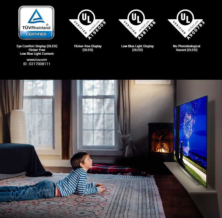 The mark of TÜV Rheinland / The mark of UL UL Verification, Boy lying on his stomach on the rug watching animation on a Blue Light-less TV