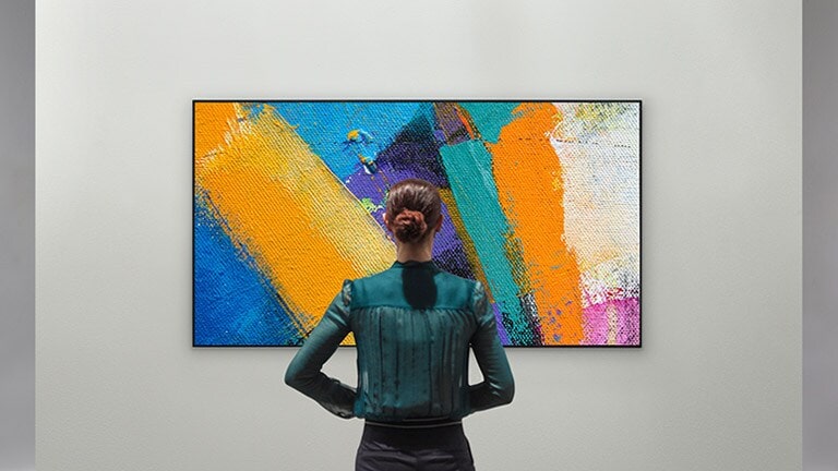 Woman enjoying an abstract artwork on a Gallery Design TV