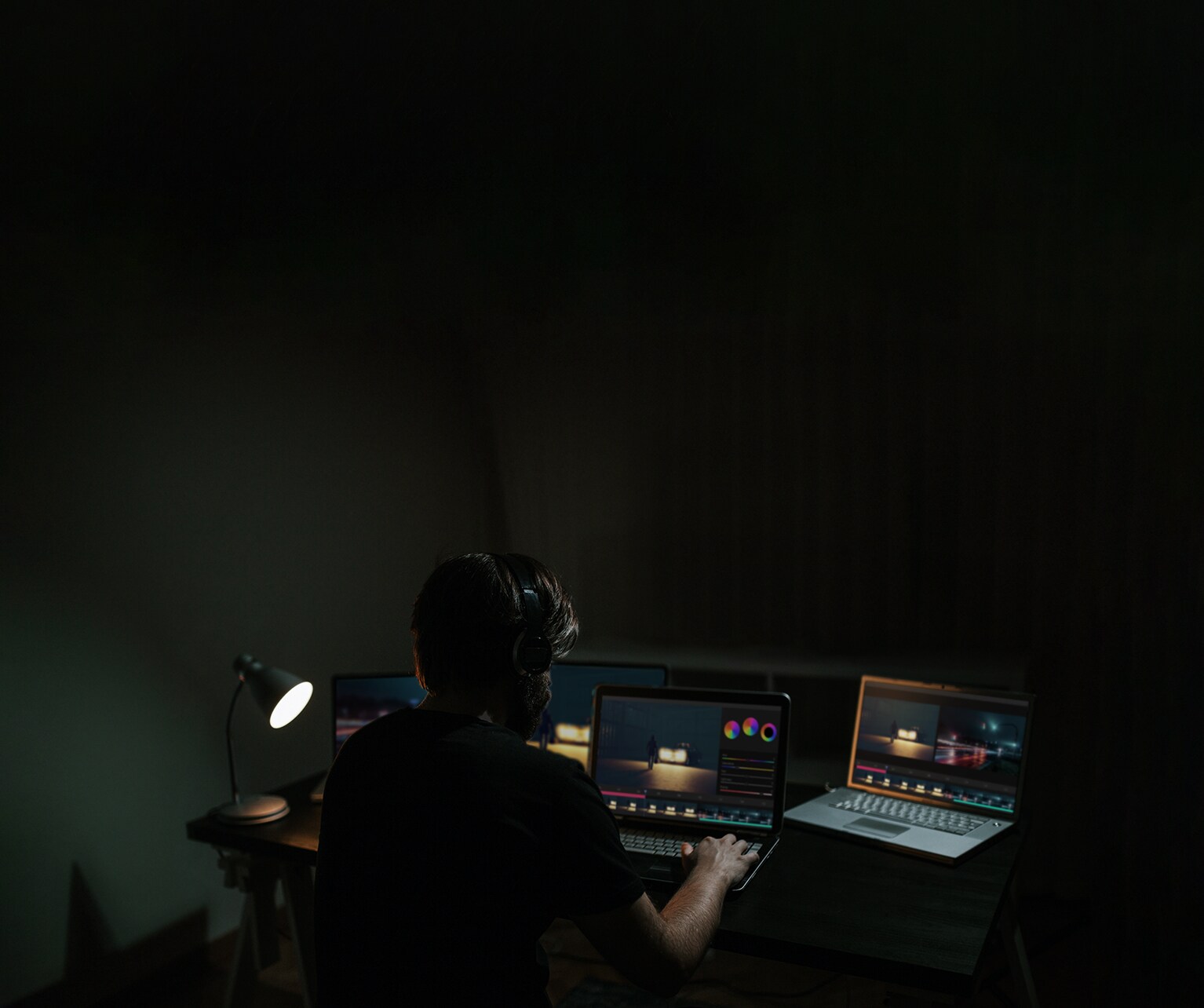 A man edits a movie while looking at the software on a computer monitor