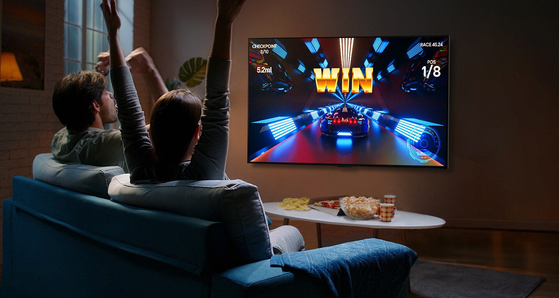 People play a game with a controller on the LG OLED television