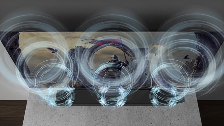 A szekrényen egy hangprojektor látható, közvetlenül a TV előtt pedig kék, kör alakú hanghullámok érkeznek a hangprojektorból.