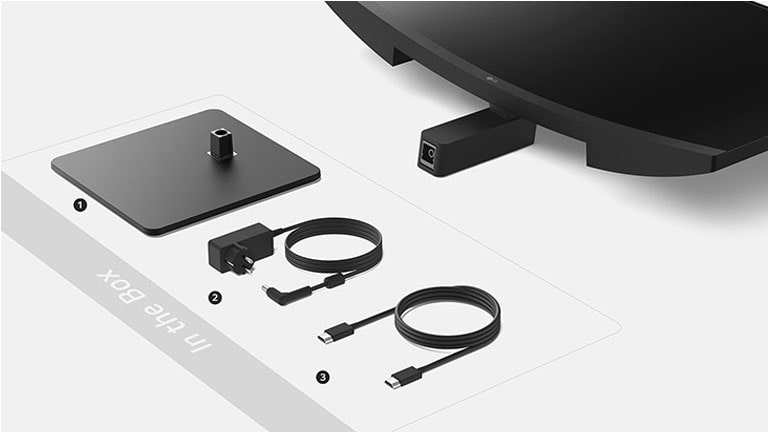 Állványtalapzat, adapter + tápkábel és HDMI-kábel a dobozban.