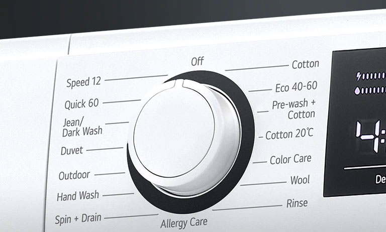 A mosógép programválasztó gombjának közelnézeti képe.
