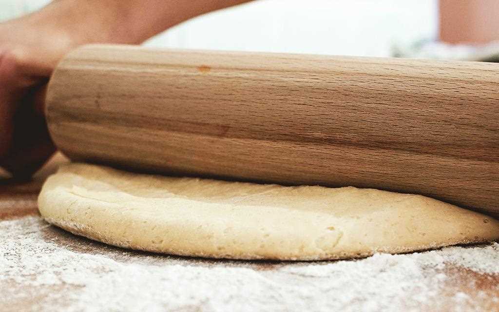 The dough is rolled flat to create pumpkin spiced cinnamon rolls in the NeoChef Countertop Microwave Oven