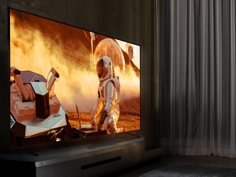 TV NanoCell di ruang santai yang gelap. Adegan film ditampilkan di layar. 