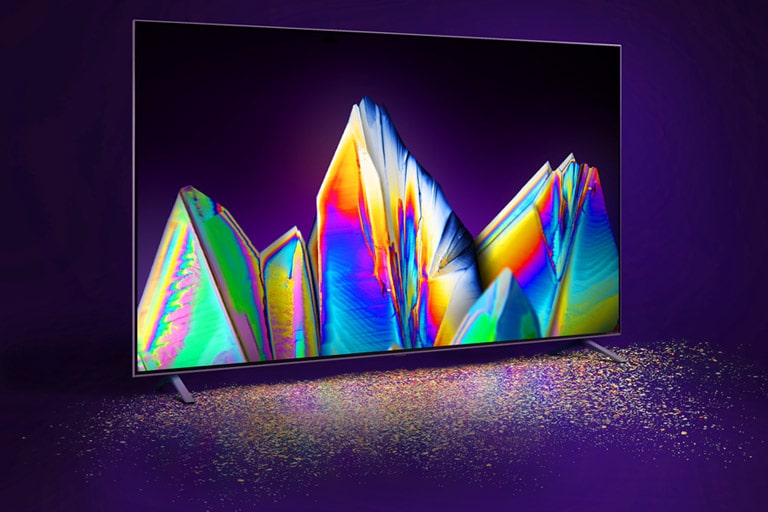 Terdapat Nanocell TV dengan gambar kristal pada layar. Partikel warna terlihat di lantai.