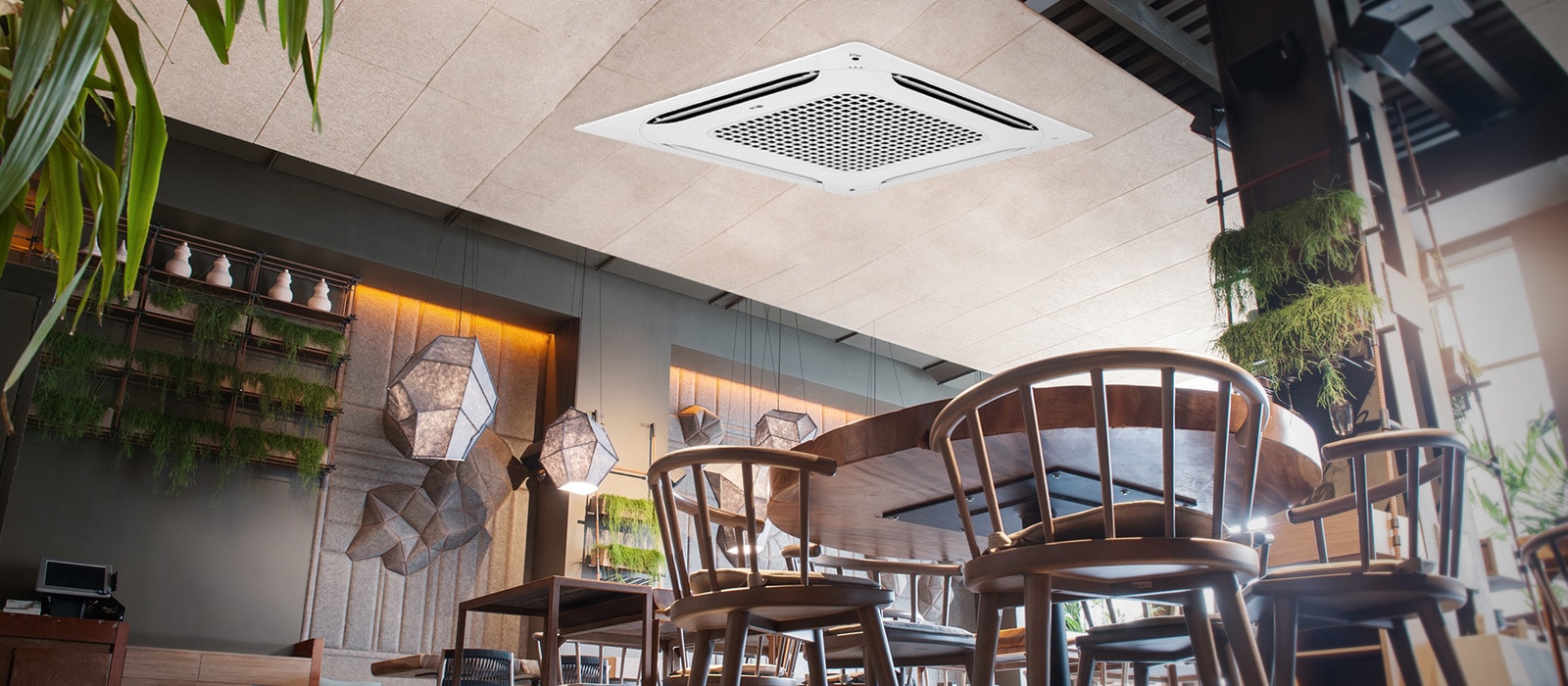 From an ant's perspective, a café unfolds, adorned with chairs, tables, and plants, while an LG round cassette is displayed at the ceiling.	