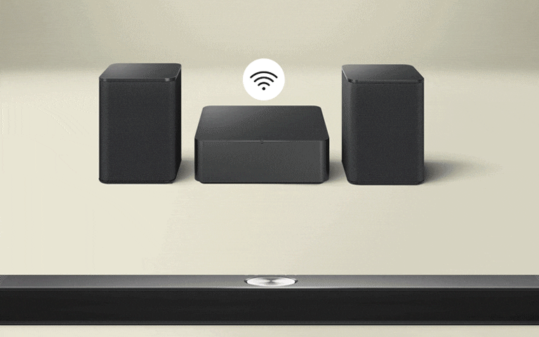 Rear speakers and Wireless Connectivity Box facing an LG Soundbar with blue curves illustrating connectivity bouncing between the box and soundbar. A black and white connectivity symbol is above the Wireless Connectivity Box. The box then fades away, and the blue curves illustrating connectivity bounce between the left rear speaker and soundbar. The black and white connectivity symbol is now above the rear speaker.