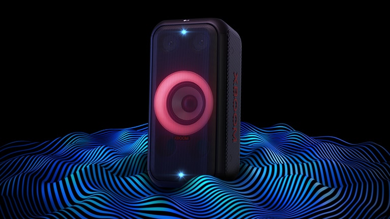 LG XL5S is standing on the infinite space. Red woofer lighting and double strobe lightings are on. On top of the speaker a sound eq is displayed. Sound waves are coming out from the bottom of the speaker in order to emphasize its deep bass.