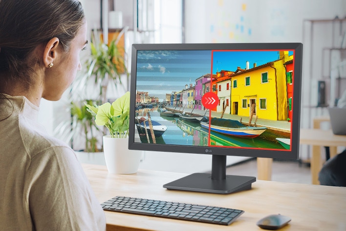 The image shows a person using an LG monitor with Flicker Safe technology, which reduces invisible screen flickering for a more comfortable viewing experience.