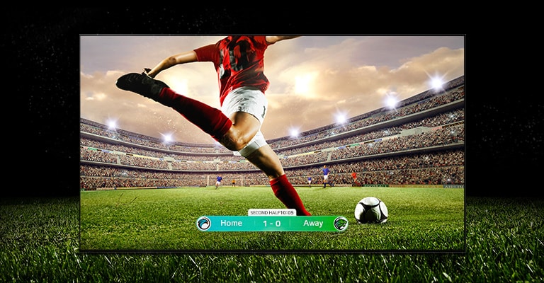 LG OLED65G3XSA An image of the display showing a soccer game with a player in a red strip about to kick the ball across the stadium. The game score is visible at the bottom of the screen. The green grass from the pitch stretches beyond the screen to the black backdrop.