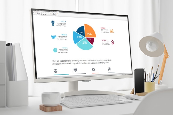On the table, there is a smart monitor, displaying a home office document being worked on. To the left of the monitor, there is a cup with a handle, and to the right, there is a mobile phone, a pencil holder, and a stand.