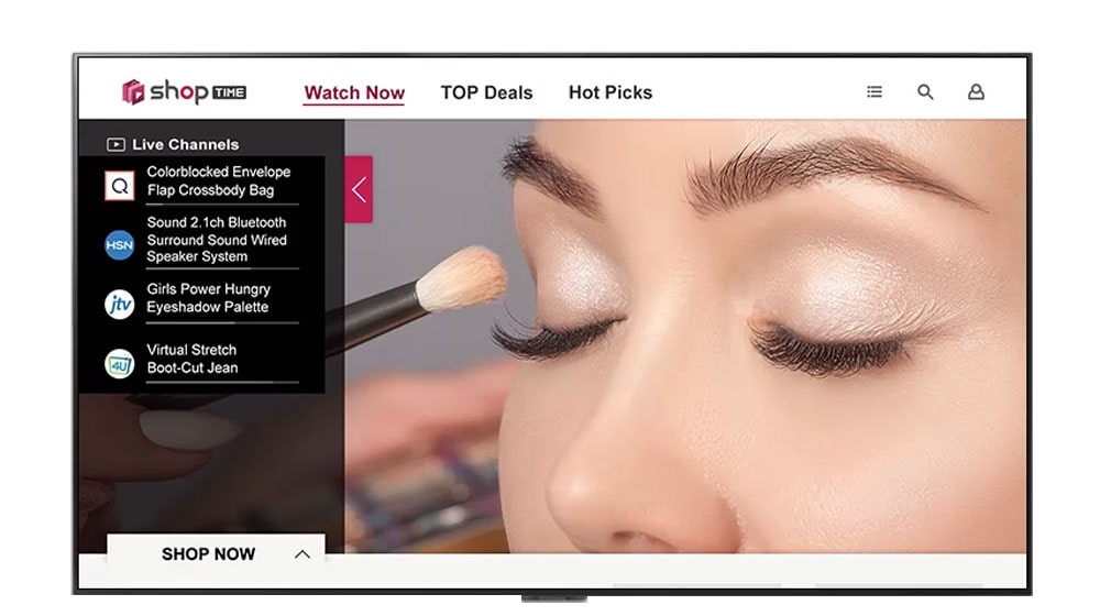 A TV screen of closeup of a woman's face getting make-up, program information to watch, and hot deals to shop.