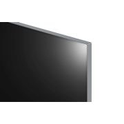 An LG OLED evo M4 within an angled perspective mounted on the wall of a bright, modern living room. A Zero Connect Box on a table in front, and a red Wi-Fi signal and red beam emitting towards the TV. The words "clutter FREE" in the bottom right corner.