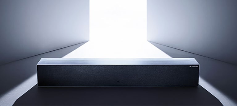 An image of LG SIGNATURE Rollable OLED TV in zero view located in a grey-colored space.