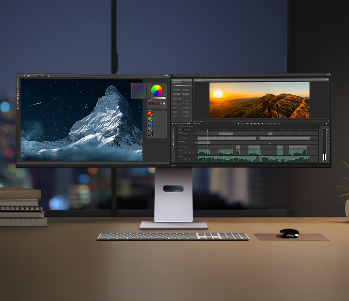 Spazio creativo notturno con il monitor LG UltraWide, che mostra software di fotoritocco e montaggio video sullo schermo ampio, circondato da accessori da scrivania e illuminazione soffusa.