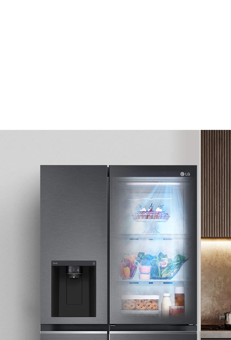 The front view of a black InstaView refrigerator with the light on inside. The contents of the refrigerator can be seen through the InstaView door. Blue rays of light shine down over the contents from the DoorCooling function.