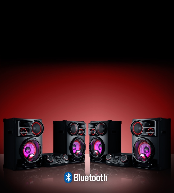 La imagen muestra un fondo viñeteado en rojo. Dos sistemas LG XBOOM CL98 están colocados sobre el suelo reflectante, uno frente al otro.