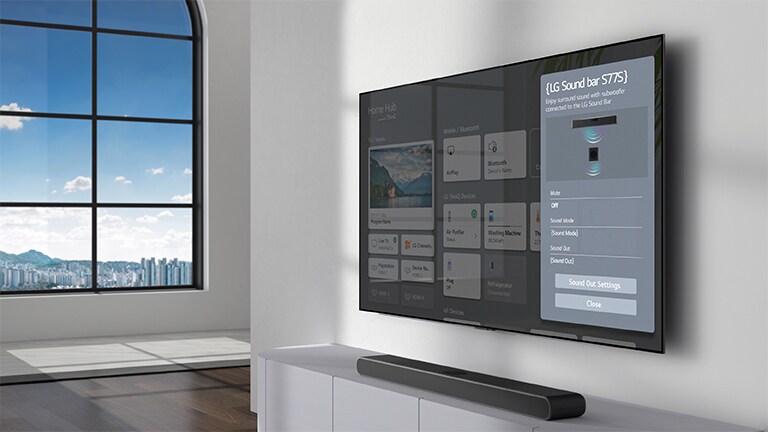 La pantalla de configuración de la barra de sonido LG se encuentra en el televisor montado en la pared. La barra de sonido también está colgada en la pared justo debajo del televisor.