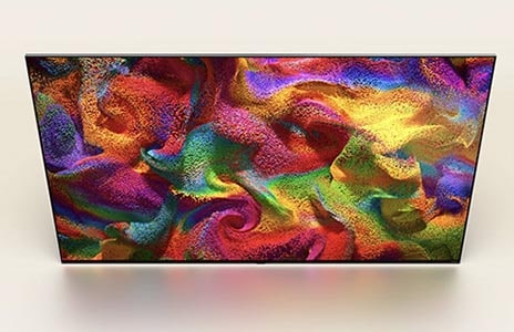 An angled overhead perspective of an LG QNED TV with an abstract, colorful artwork on screen.