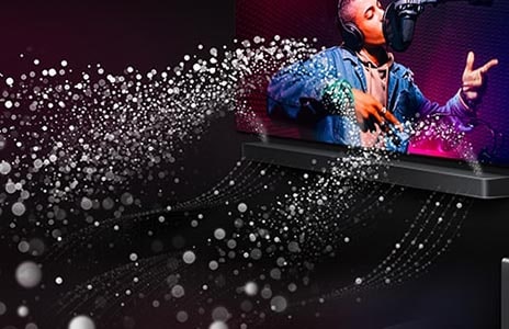 LG TV and LG Soundbar are in a black room playing a musical performance. White droplets representing soundwaves shoot upwards and forward from the soundbar.