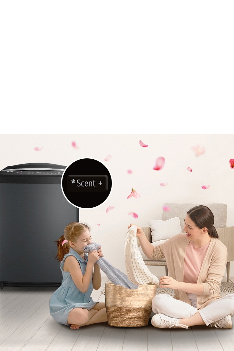 The 'scent' button on the LG washing machine is emphasized, a mother and daughter sit on the floor enjoying the smell of a towel that just came out of the washing machine that sits next to them. Petals are flying around them.