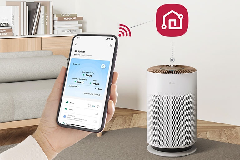 There is a hand holding a cell phone that shows the LG ThinQ app screen on the left, the LG ThinQ logo on the right, and there is a Puricare air purifier under it, it is linked to the cell phone.