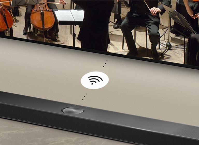 A close up of an LG Soundbar below a LG TV. A connectivity symbol is in between LG Soundbar and a LG TV, showing WOWCAST's wireless operation.