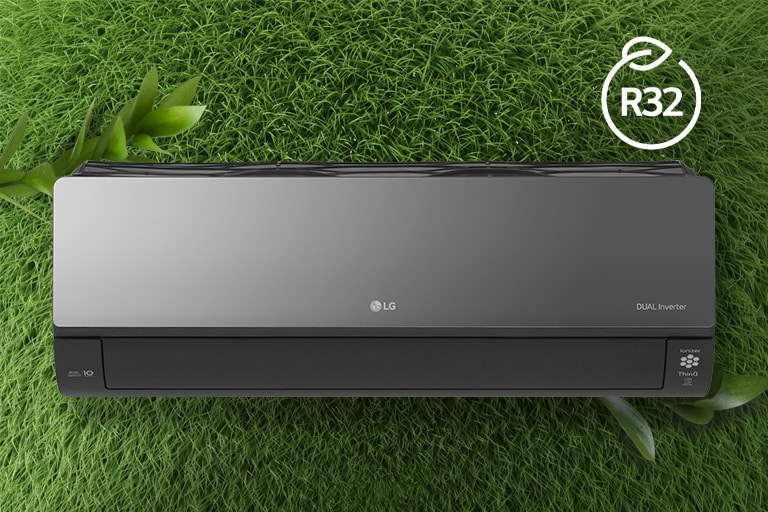 The LG Air conditioner is installed on a wall of grass. The R32 logo for energy efficiency is in the upper right corner.