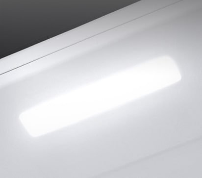 The top interior of the fridge is shown with the soft LED light bright.