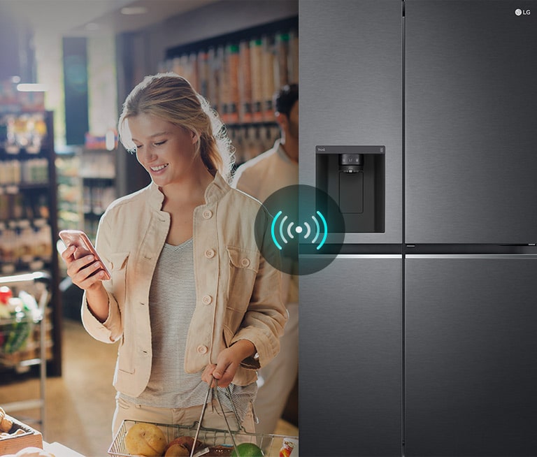 Image on the left shows a woman standing in a grocery store looking at her phone. Image on the right shows the refrigerator front view. In the center of the images is an icon to show connectivity between the phone and refrigerator.