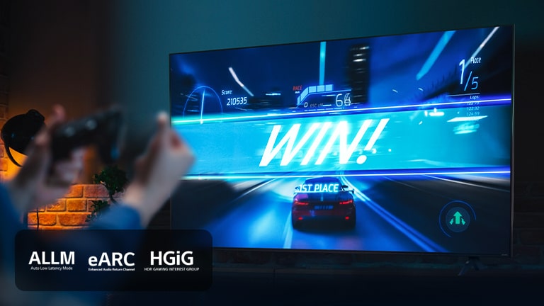 An image of LG TV showing a car racing game on the finish line, with the sign saying 'WIN!', as the player clenches on to the game joystick. ALLM, eARC, HGiG logo are place on the bottom left corner.