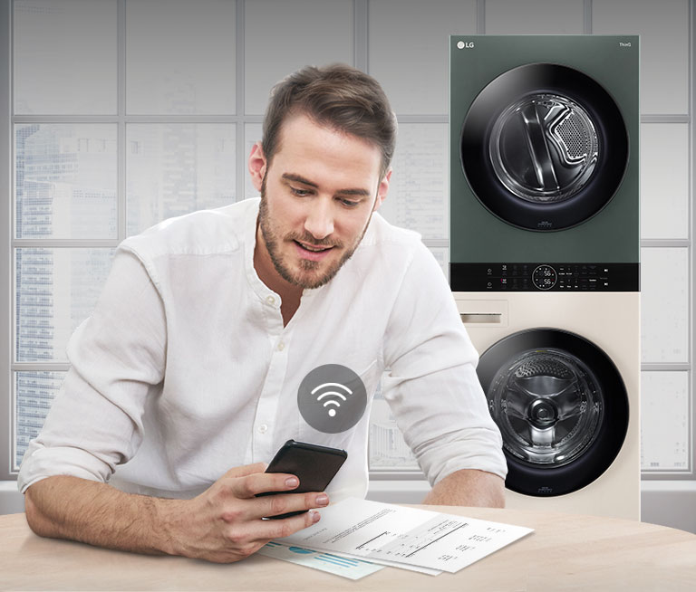 A man is monitoring the condition of the WashTower via the LG ThinQ app.