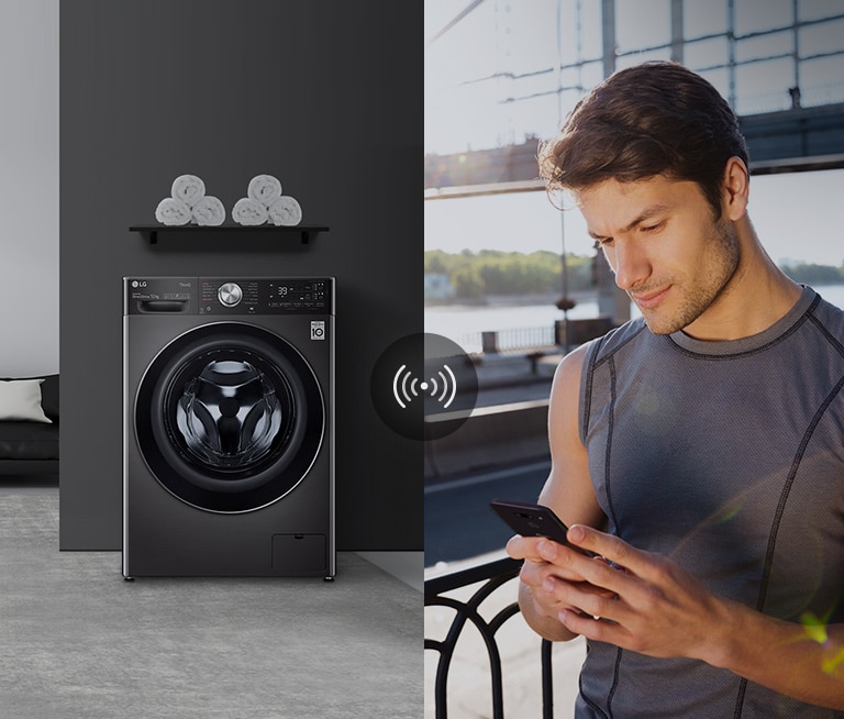 A man outdoors is checking the condition of a washing machine at home through a mobile phone app.