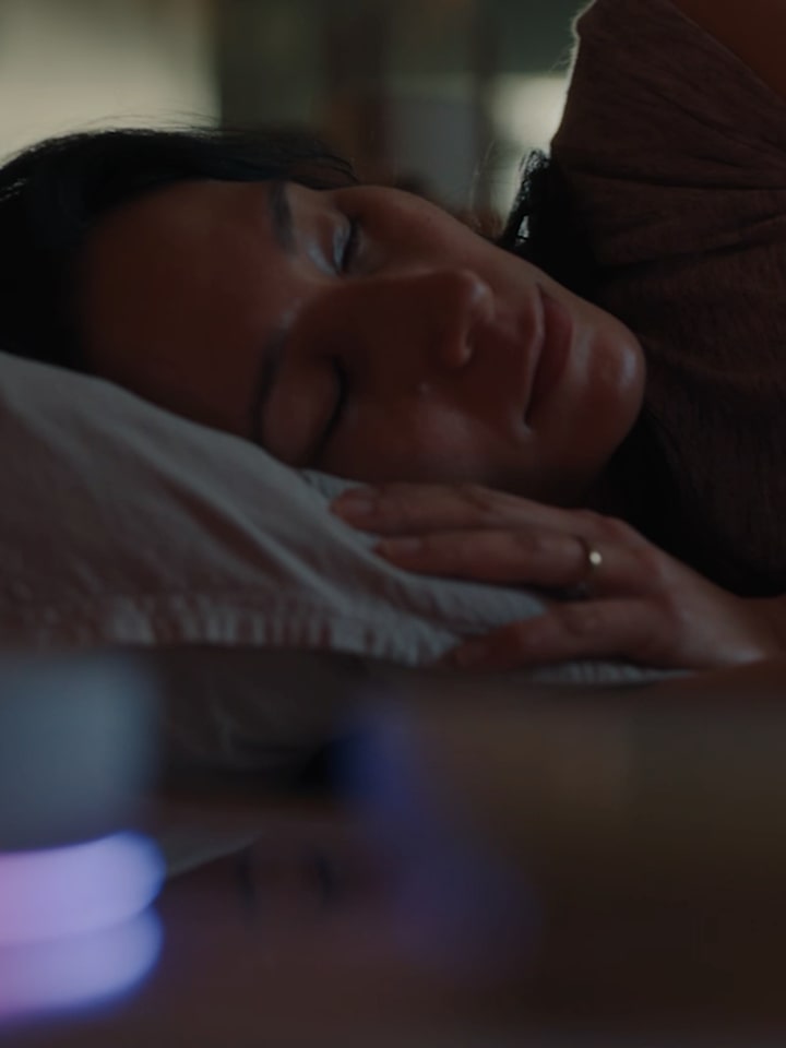 A man and a woman lie intertwined on the living room sofa while the LG TV plays  a cooking channel. After the woman falls asleep, the man calls out, &quot;Hi LG,&quot; asking to  play the soccer match, and the channel switches to the game.