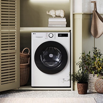 De witte LG 9 kg wasmachine GD3R509S0 met zijn strakke design, netjes geïnstalleerd onder het aanrecht van een moderne wasruimte.