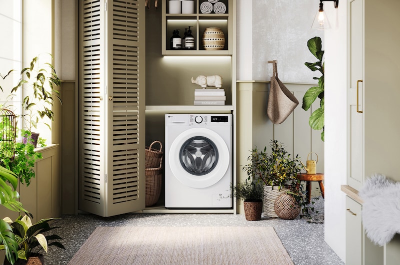 De witte LG 9kg wasmachine F4DR3096N3W met zijn strakke design, netjes geïnstalleerd onder het aanrecht van een moderne wasruimte.