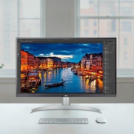 LG Monitor 27UP850K in een wit/zilveren ontwerp op een helder bureau, toont fotobewerkingssoftware en benadrukt de precieze en heldere 4K-beeldkwaliteit.