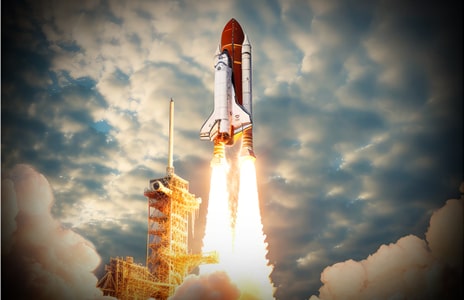 An image of a dolphin jumping out of the water before a starry night sky. Above the whale is the phrase "up to 150% brighter".