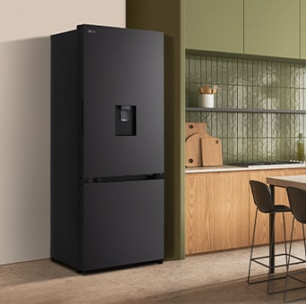 A modern lg black bottom freezer refrigerator with water dispenser is seamlessly fit next to a wooden kitchen countertop.