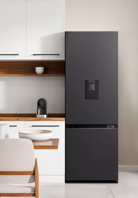 The front view of lg bottom freezer refrigerator with water dispenser in a white modern kitchen room.