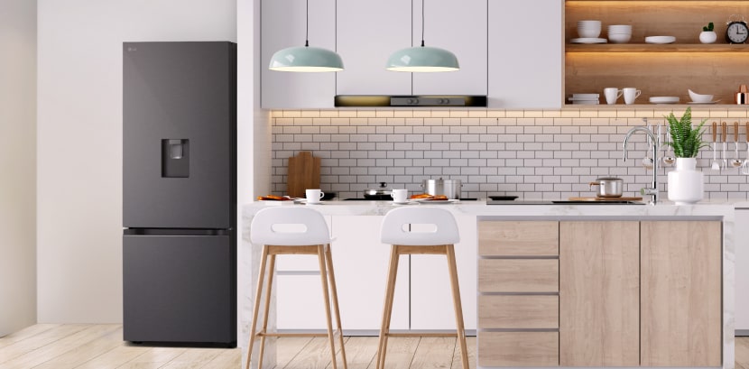 The overall view of lg bottom freezer refrigerator with water dispenser in a kitchen.