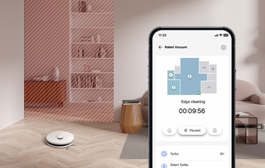 Image of a close-up mobile phone screen and a robot vacuum cleaning the floor.	