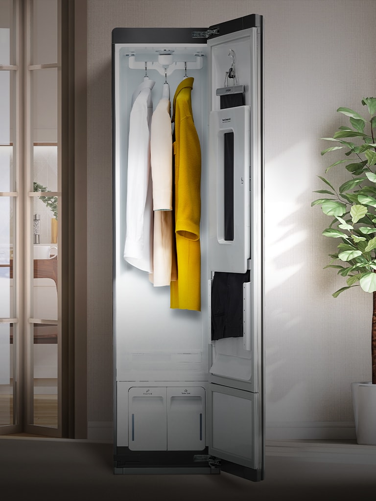 Image shows Styler door open with clothes handing inside, within a in bright home