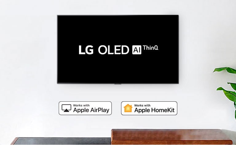 TV montada en la pared que muestra el logotipo de LG OLED AI ThinQ sobre un fondo negro