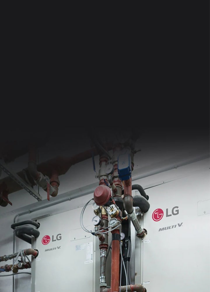 In the mechanical room, an intricate black and red piping network weaves around two LG Multi V units installed on the side wall.