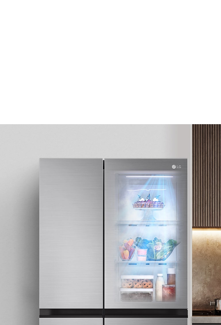 The front view of a black InstaView refrigerator with the light on inside. The contents of the refrigerator can be seen through the InstaView door. Blue rays of light shine down over the contents from the DoorCooling function.